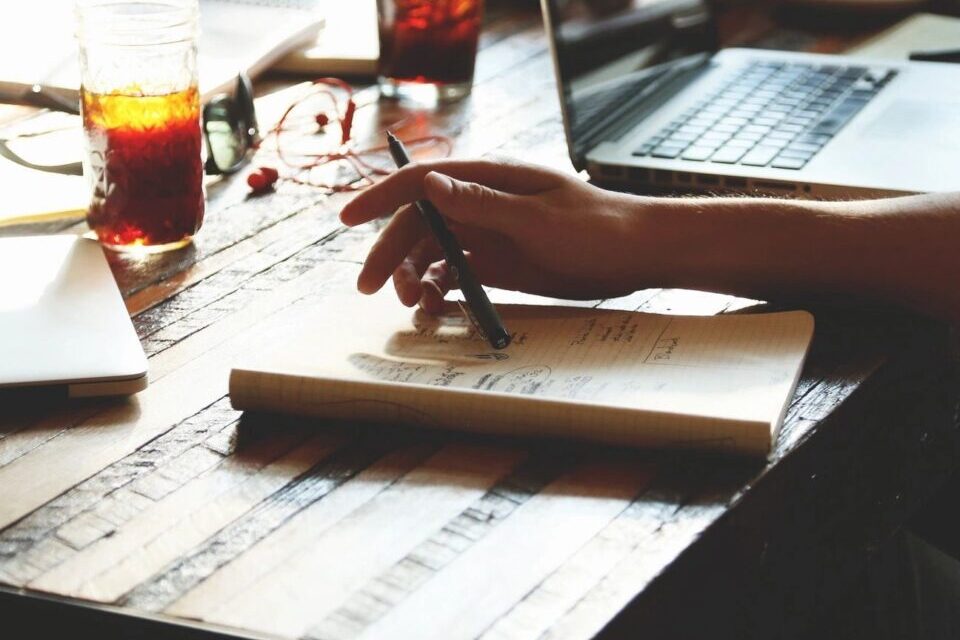 Occupational therapist writing notes during a community home visit